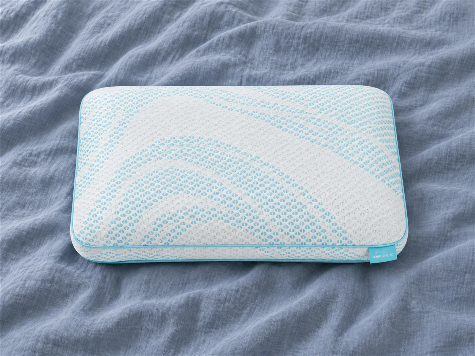 Tempur-Pedic TEMPUR-Breeze Pro + Advanced Cooling Pillow: Front view on blue-gray linen